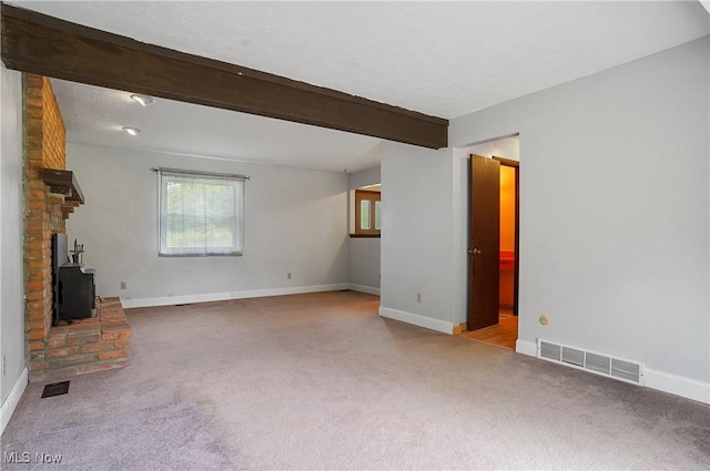 12230 Painesville Warren Rd, Concord, OH 44077 - unfurnished living room featuring carpet flooring, beam ceiling, and a wood stove