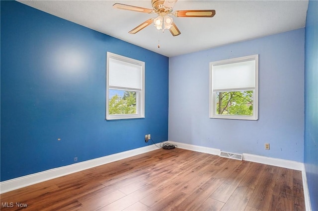 12230 Painesville Warren Rd, Concord, OH 44077 - empty room with wood finished floors and ceiling fan