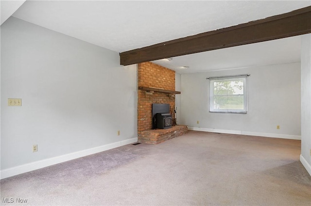 12230 Painesville Warren Rd, Concord, OH 44077 - unfurnished living room with beamed ceiling, carpet flooring, and a wood stove