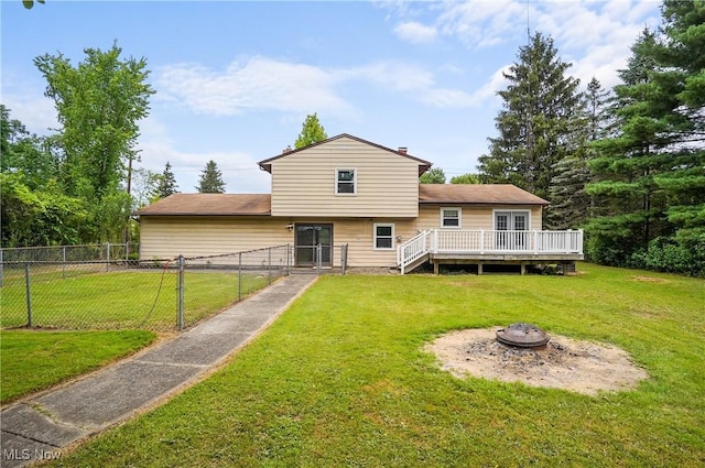 12230 Painesville Warren Rd, Concord, OH 44077 - rear view of house featuring a wooden deck and a fire pit