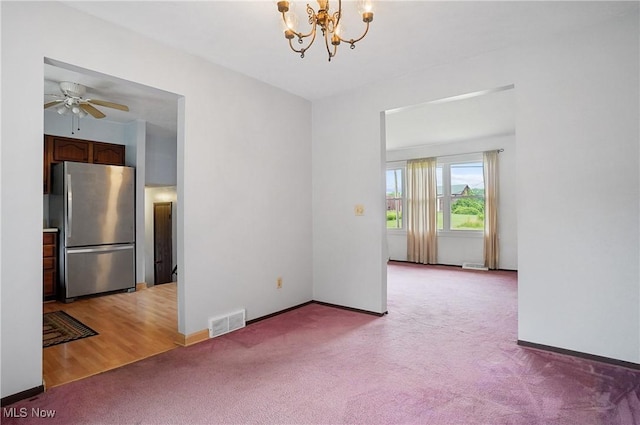 12230 Painesville Warren Rd, Concord, OH 44077 - spare room featuring light colored carpet, a chandelier, and ceiling fan