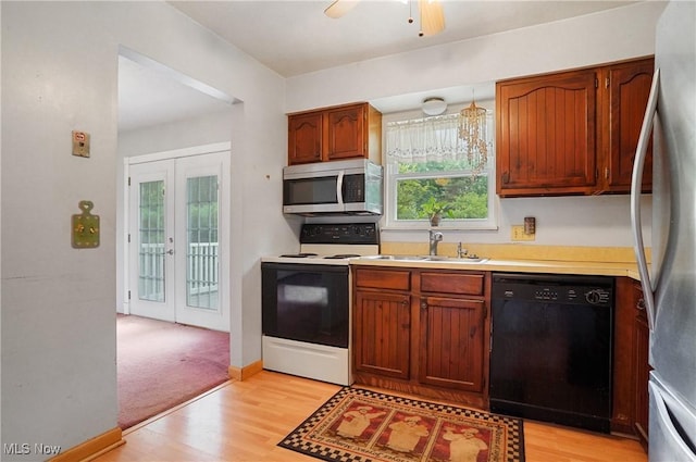 12230 Painesville Warren Rd, Concord, OH 44077 - kitchen with appliances with stainless steel finishes, french doors, light wood-style flooring, and light countertops