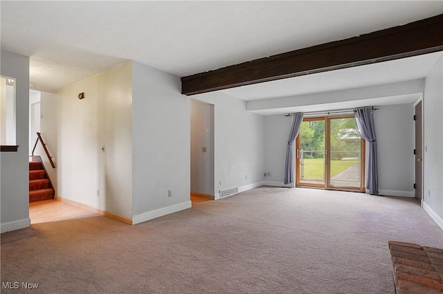 12230 Painesville Warren Rd, Concord, OH 44077 - unfurnished living room featuring carpet floors, stairway, and beam ceiling