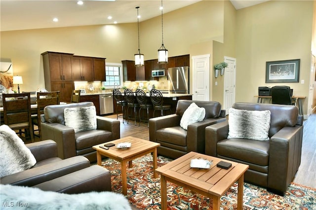 12 Bayview Cir, Cortland, OH 44410 - living area with light wood-type flooring, high vaulted ceiling, and recessed lighting