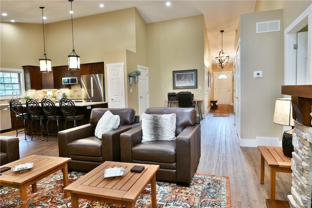 12 Bayview Cir, Cortland, OH 44410 - living area featuring high vaulted ceiling, wood finished floors, and recessed lighting