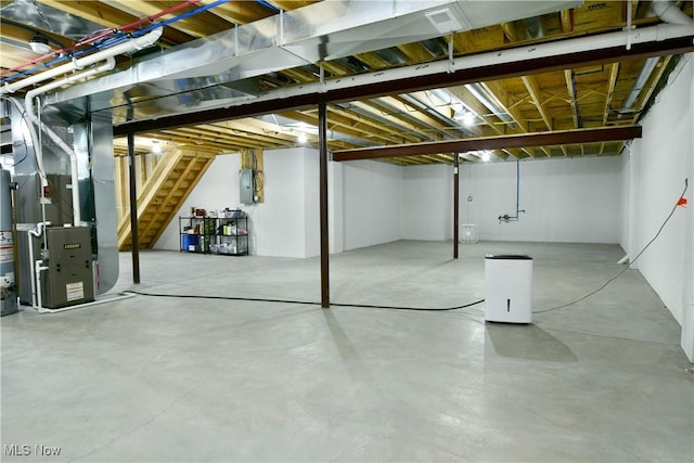 12 Bayview Cir, Cortland, OH 44410 - unfinished basement featuring stairway, electric panel, heating unit, and gas water heater