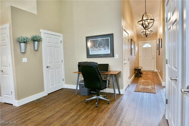 12 Bayview Cir, Cortland, OH 44410 - home office featuring a chandelier, wood finished floors, and a towering ceiling