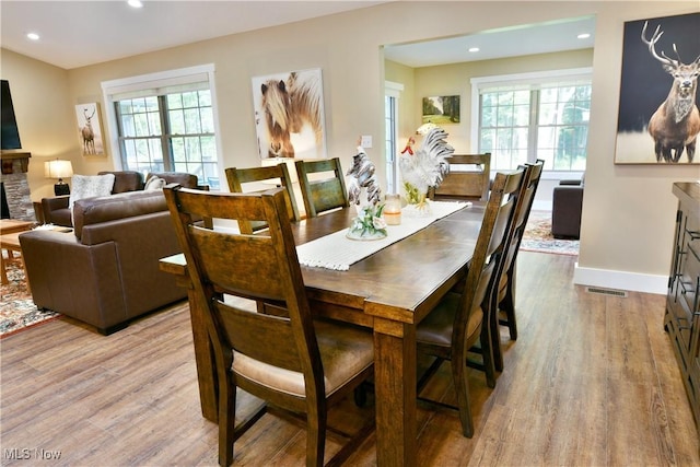 12 Bayview Cir, Cortland, OH 44410 - dining area featuring wood finished floors, recessed lighting, and a fireplace