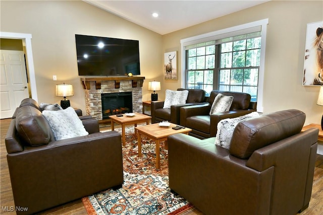 12 Bayview Cir, Cortland, OH 44410 - living area with lofted ceiling, wood finished floors, and a stone fireplace