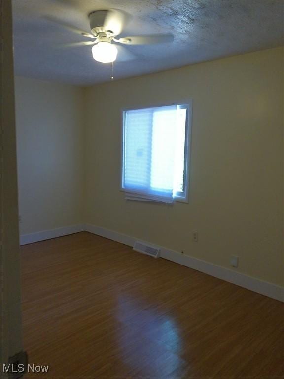1064 E 168th St, Cleveland, OH 44110 - spare room with ceiling fan and wood finished floors