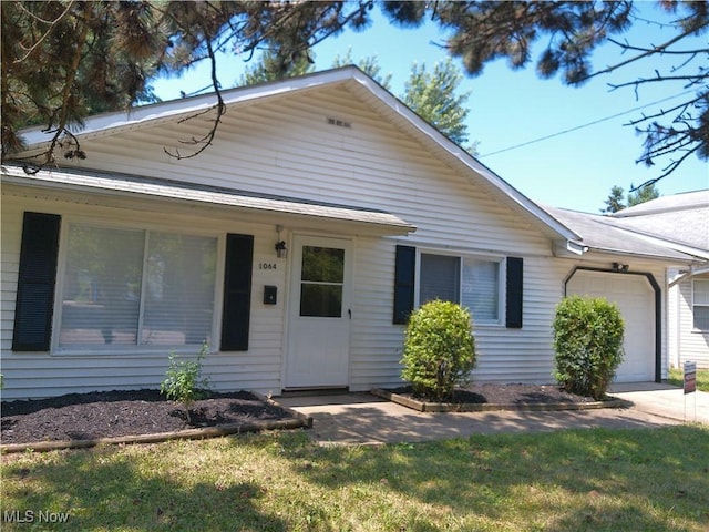 1064 E 168th St, Cleveland, OH 44110 - ranch-style house with an attached garage and a front lawn