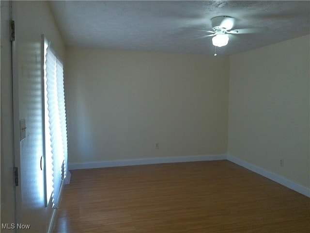1064 E 168th St, Cleveland, OH 44110 - spare room with wood finished floors, a ceiling fan, and a textured ceiling