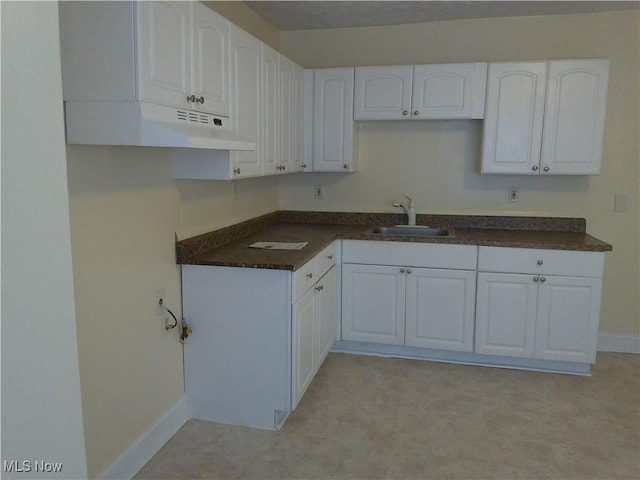 1064 E 168th St, Cleveland, OH 44110 - kitchen with white cabinets and dark countertops