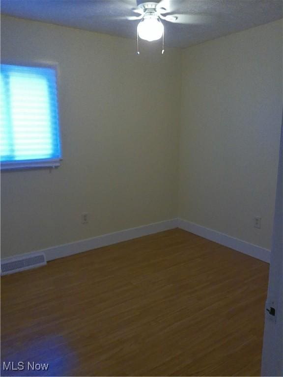 1064 E 168th St, Cleveland, OH 44110 - spare room featuring ceiling fan and wood finished floors