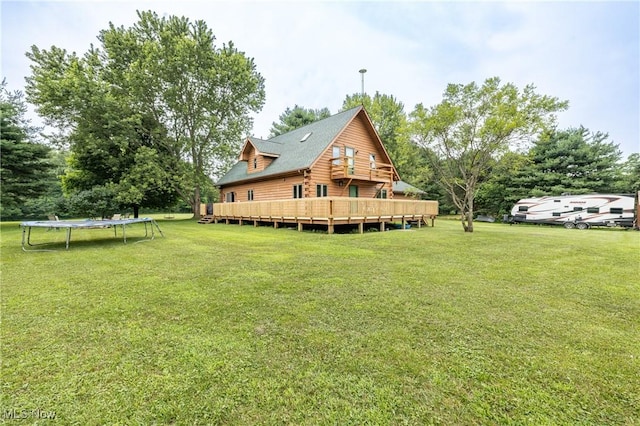 5621 Schustrich Rd, Mantua, OH 44255 - rear view of house featuring a trampoline, a yard, and a deck