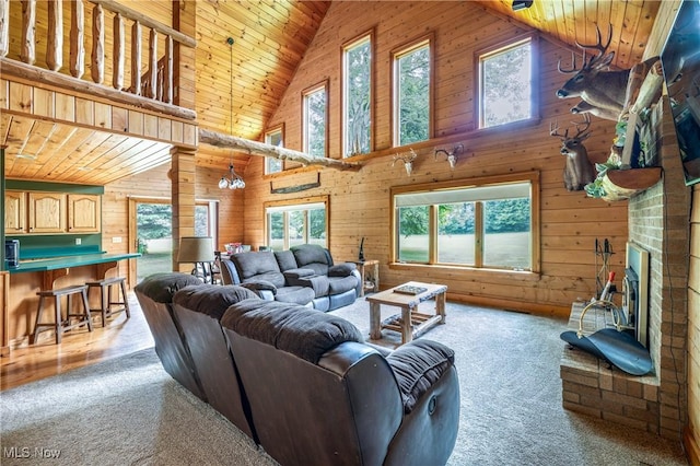 5621 Schustrich Rd, Mantua, OH 44255 - living room featuring high vaulted ceiling, plenty of natural light, wooden walls, carpet flooring, and wood ceiling