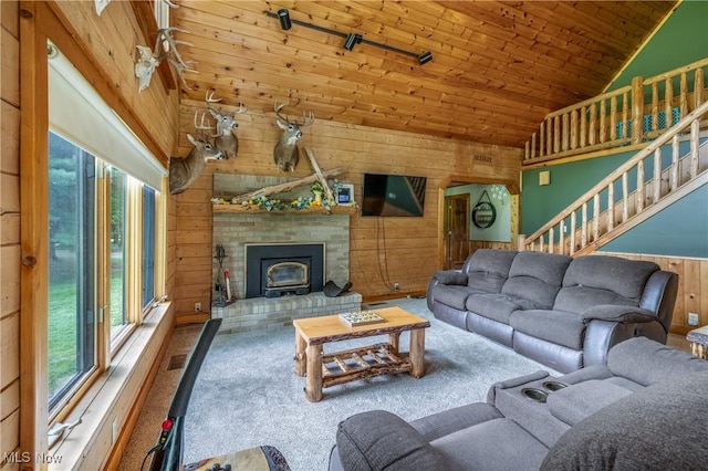 5621 Schustrich Rd, Mantua, OH 44255 - carpeted living room featuring wooden walls, healthy amount of natural light, wooden ceiling, high vaulted ceiling, and stairs