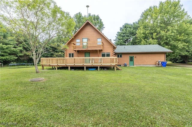 5621 Schustrich Rd, Mantua, OH 44255 - rear view of property with log siding, a wooden deck, a yard, and a trampoline