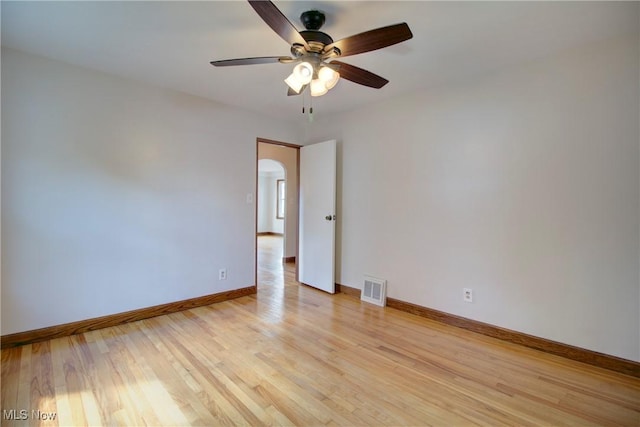 8102 Bertha Ave, Parma, OH 44129 - empty room featuring ceiling fan, light wood finished floors, and arched walkways