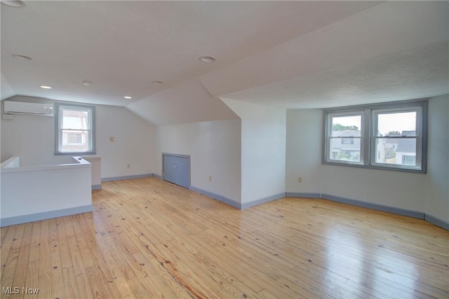 8102 Bertha Ave, Parma, OH 44129 - bonus room with a wall mounted AC, light wood-style flooring, and vaulted ceiling