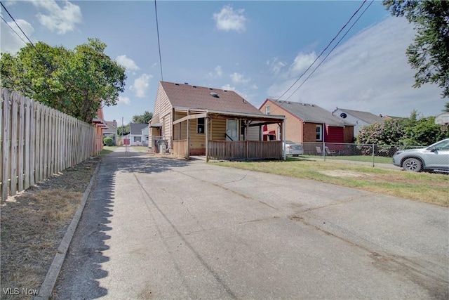 8102 Bertha Ave, Parma, OH 44129 - view of front of house with driveway, a fenced front yard, and a gate