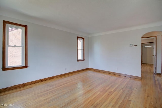 8102 Bertha Ave, Parma, OH 44129 - spare room with arched walkways and light wood-style floors
