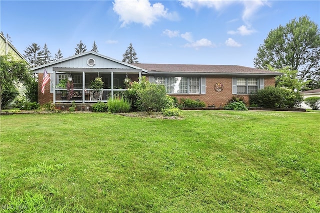 136 Elmridge Rd, Mansfield, OH 44907 - ranch-style house featuring brick siding, a front yard, and a sunroom