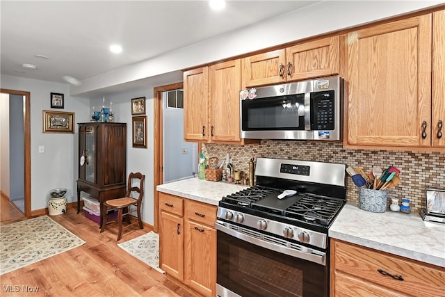 136 Elmridge Rd, Mansfield, OH 44907 - kitchen with appliances with stainless steel finishes, light countertops, light wood-style floors, decorative backsplash, and recessed lighting