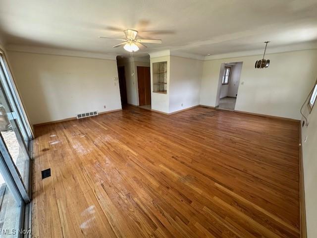 8375 Royal Ridge Dr, Parma, OH 44129 - unfurnished room with light wood-style flooring, a ceiling fan, and crown molding