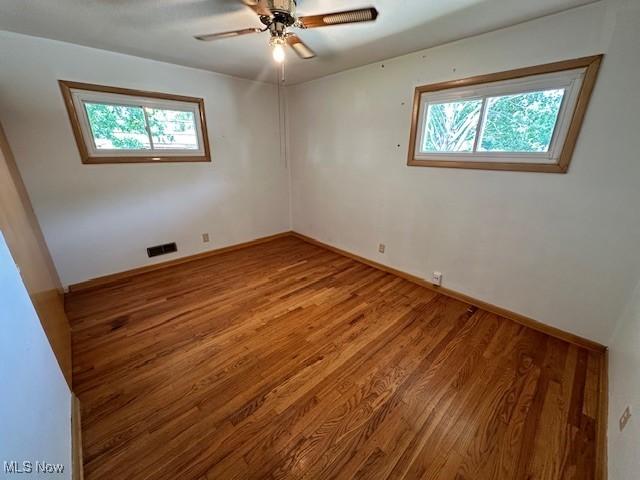 8375 Royal Ridge Dr, Parma, OH 44129 - unfurnished room with plenty of natural light, wood finished floors, and a ceiling fan