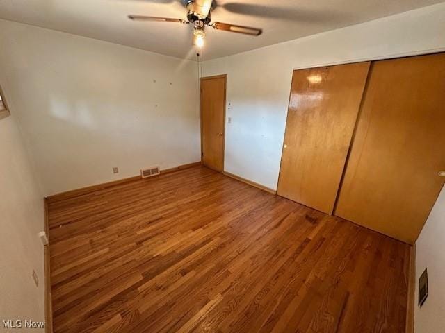 8375 Royal Ridge Dr, Parma, OH 44129 - unfurnished bedroom with wood finished floors, a closet, and ceiling fan