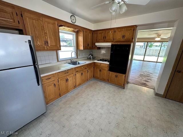 8375 Royal Ridge Dr, Parma, OH 44129 - kitchen featuring freestanding refrigerator, ceiling fan, under cabinet range hood, and light floors