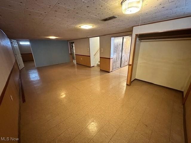 8375 Royal Ridge Dr, Parma, OH 44129 - finished basement with tile patterned floors, wainscoting, and stairway