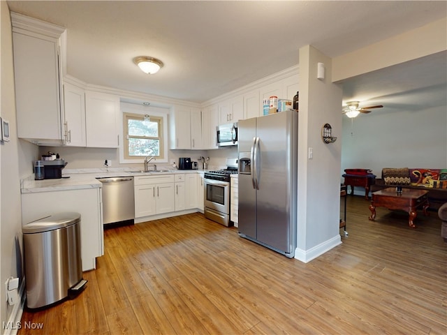 1345 E 359th St, Eastlake, OH 44095 - kitchen with appliances with stainless steel finishes, white cabinets, and light countertops