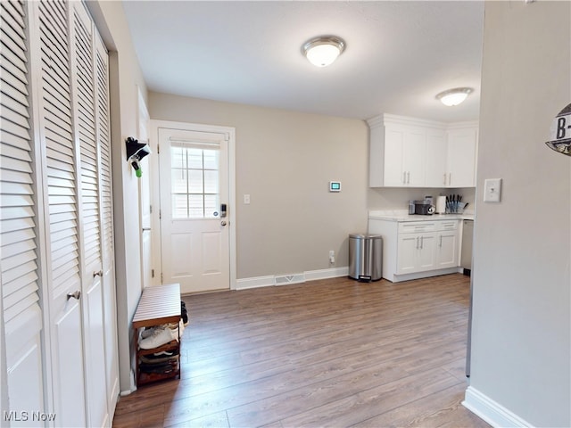 1345 E 359th St, Eastlake, OH 44095 - interior space with white cabinets, light wood-type flooring, and light countertops