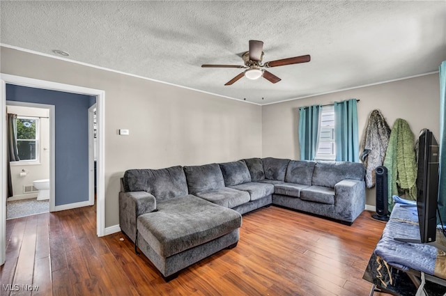 21100 Watson Rd, Maple Heights, OH 44137 - living room featuring hardwood / wood-style flooring, a ceiling fan, a textured ceiling, and ornamental molding