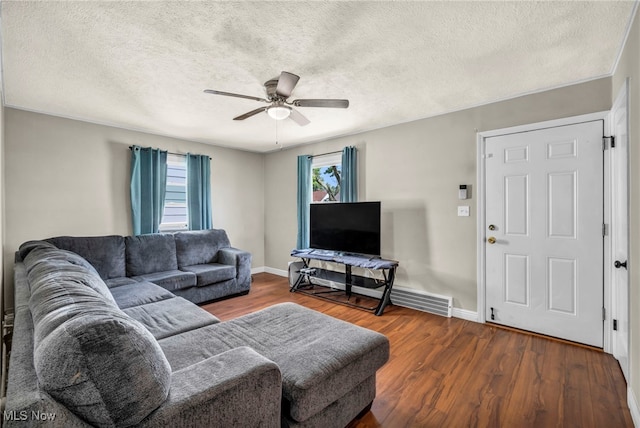 21100 Watson Rd, Maple Heights, OH 44137 - living room featuring wood finished floors, a ceiling fan, and a textured ceiling