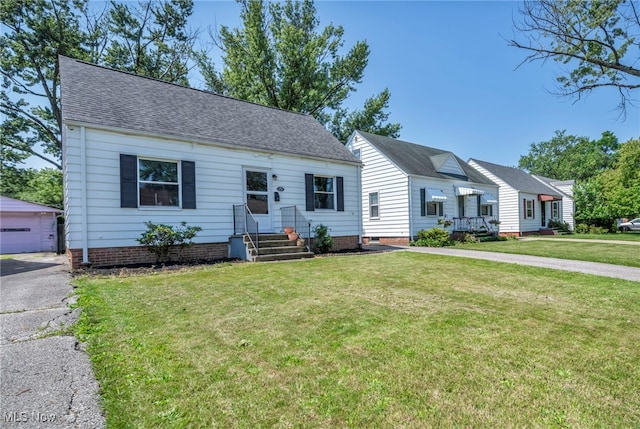 21100 Watson Rd, Maple Heights, OH 44137 - bungalow-style house with an outdoor structure, a front lawn, a shingled roof, and a detached garage