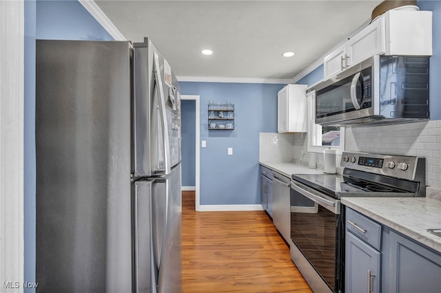 21100 Watson Rd, Maple Heights, OH 44137 - kitchen with stainless steel appliances, wood finished floors, backsplash, ornamental molding, and recessed lighting