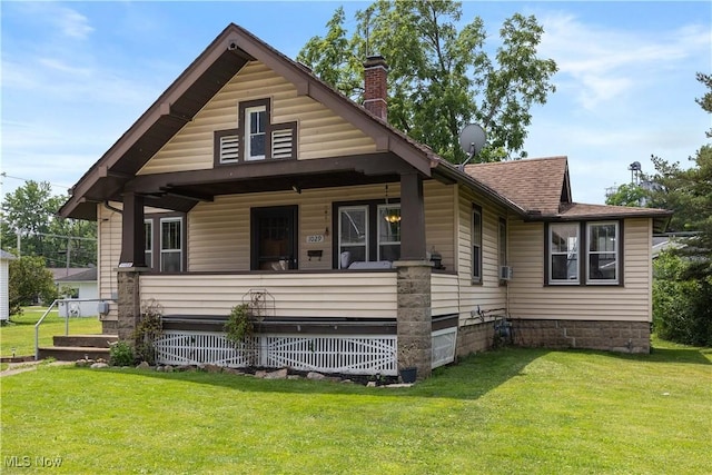 1029 S Main St, Grafton, OH 44044 - view of front of house with a chimney, a front lawn, covered porch, and roof with shingles