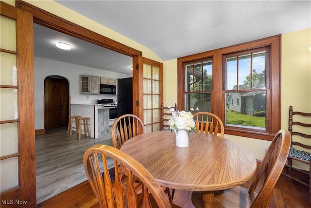 1029 S Main St, Grafton, OH 44044 - dining room featuring arched walkways, wood finished floors, and lofted ceiling