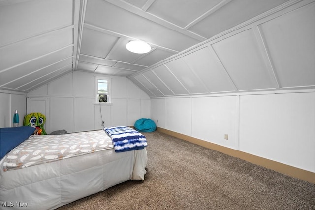 1029 S Main St, Grafton, OH 44044 - carpeted bedroom featuring a decorative wall and lofted ceiling