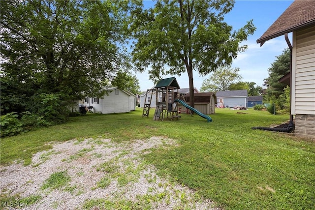 1029 S Main St, Grafton, OH 44044 - view of grassy yard featuring a playground and a storage unit