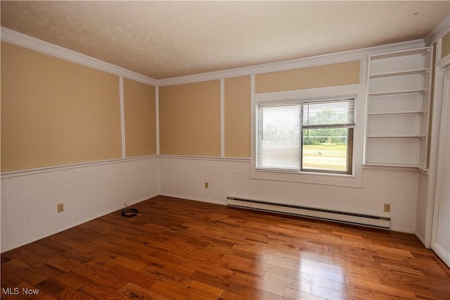 9306 Beech St, Louisville, OH 44641 - unfurnished room featuring baseboard heating, wood finished floors, ornamental molding, and wainscoting