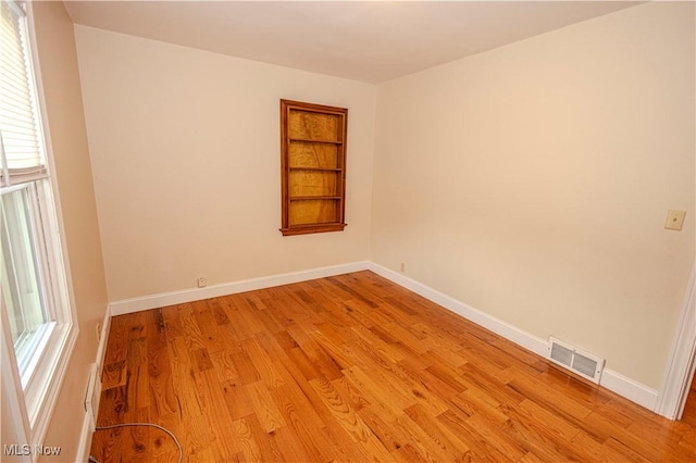 9306 Beech St, Louisville, OH 44641 - spare room featuring light wood-style flooring and built in shelves