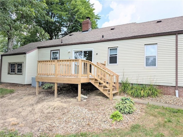9306 Beech St, Louisville, OH 44641 - back of house with a deck, a chimney, and roof with shingles