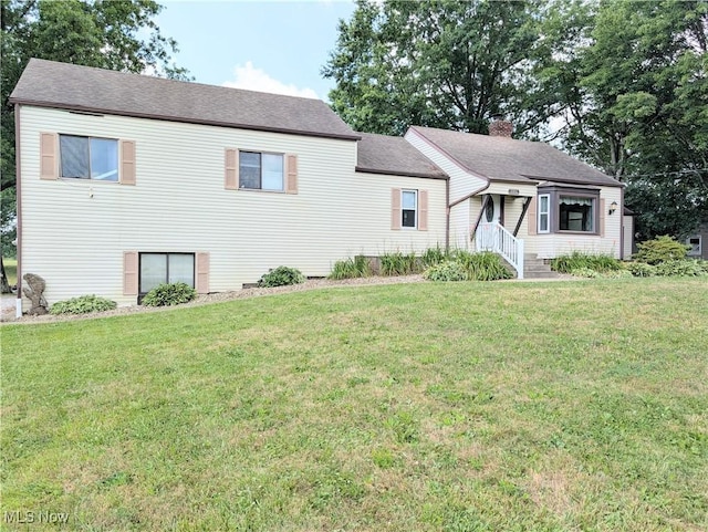 9306 Beech St, Louisville, OH 44641 - view of front facade with a front lawn, a chimney, and roof with shingles