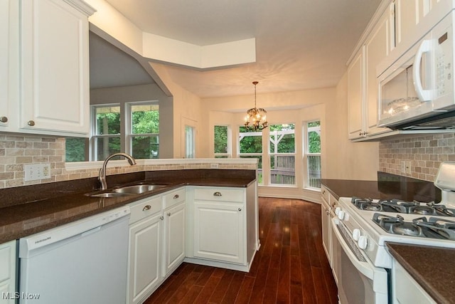 583 Mock Orange Cir, Chagrin Falls, OH 44023 - kitchen with white appliances, a peninsula, a chandelier, white cabinets, and dark wood finished floors