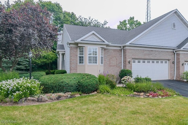 583 Mock Orange Cir, Chagrin Falls, OH 44023 - ranch-style home with brick siding, a front yard, a garage, driveway, and roof with shingles