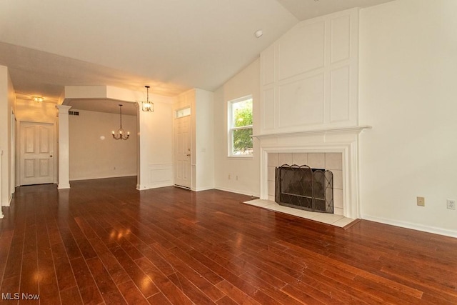 583 Mock Orange Cir, Chagrin Falls, OH 44023 - unfurnished living room featuring a chandelier, a fireplace, wood finished floors, and vaulted ceiling
